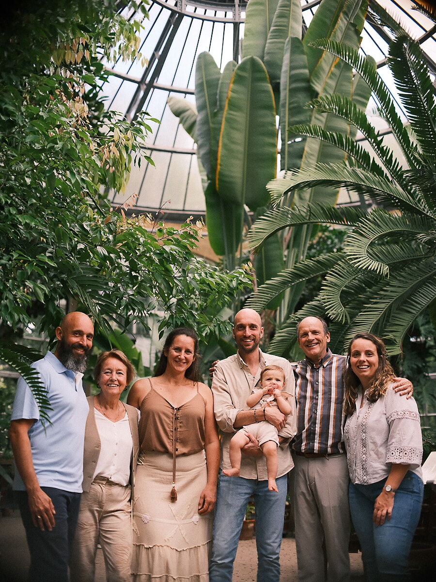 One family across three generations under the palms of a glass greenhouse in Amsterdam
