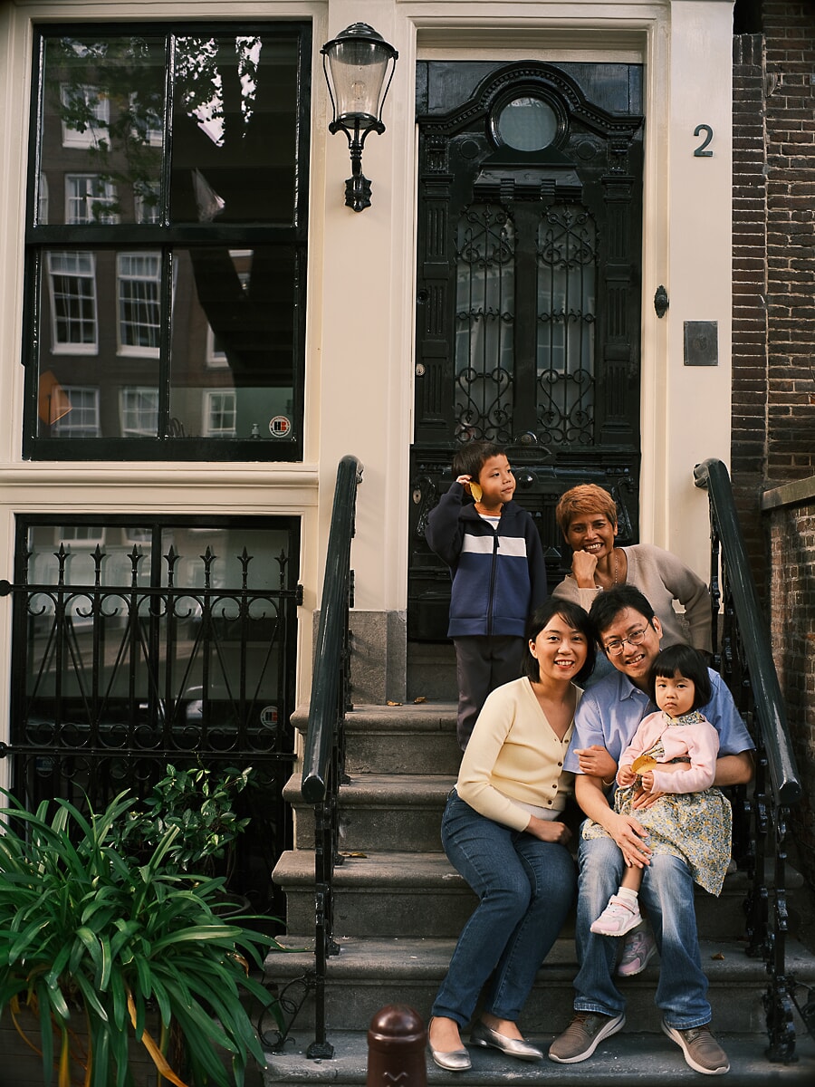Family of five on the steps of an Amsterdam canal house, three generations together during their family session