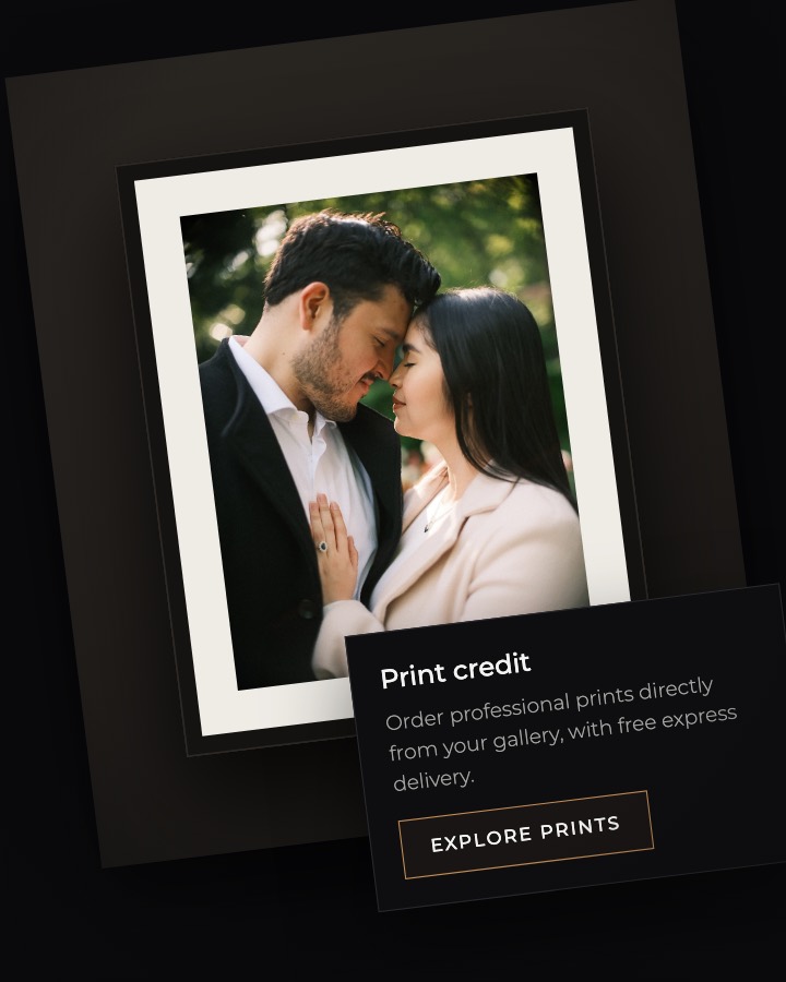 Framed print of a couple touching foreheads, hanging on a dark wall above a print credit card from the online gallery